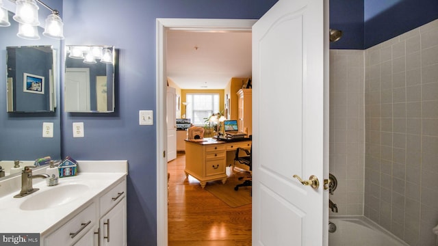 bathroom with  shower combination, wood finished floors, and vanity