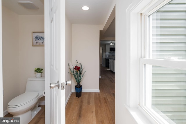 bathroom featuring baseboards, visible vents, toilet, and wood finished floors