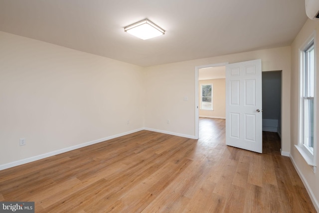 unfurnished room featuring light wood-style floors and baseboards