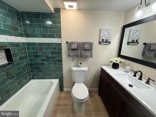 full bathroom featuring tub / shower combination, vanity, toilet, and baseboards