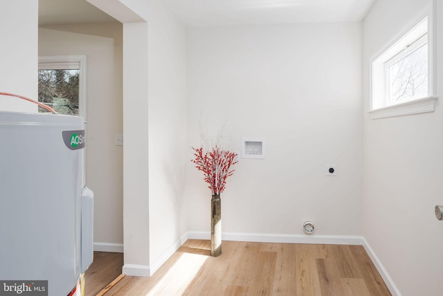 laundry area with washer hookup, baseboards, hookup for an electric dryer, and light wood finished floors