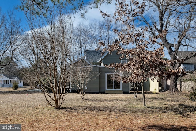 view of side of home featuring a lawn