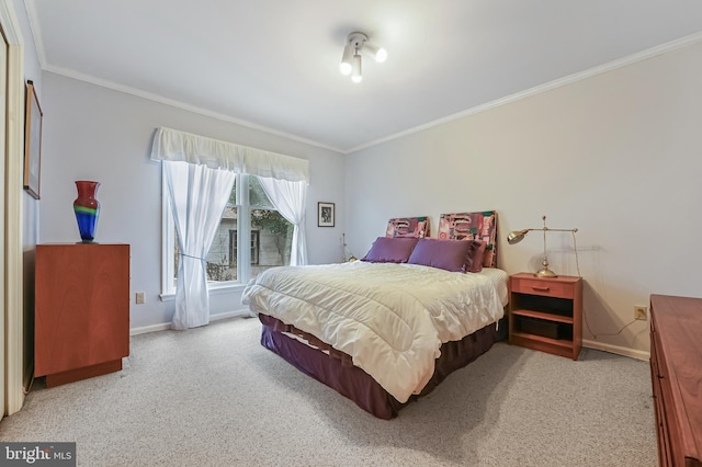 bedroom with ornamental molding, carpet, and baseboards