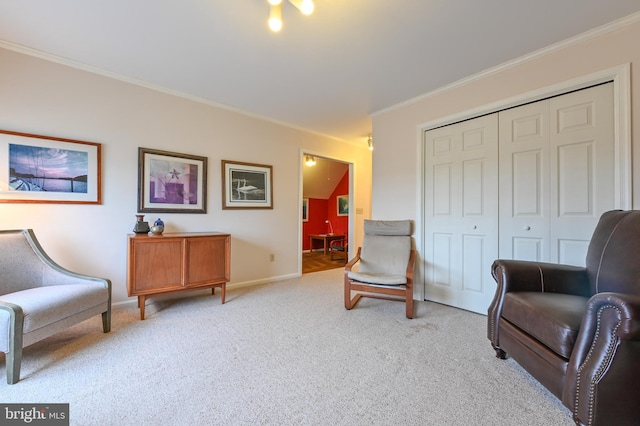 sitting room with baseboards, ornamental molding, and light colored carpet