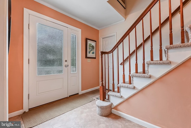 foyer entrance featuring stairs, crown molding, and baseboards