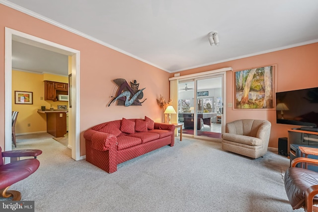 living room featuring light carpet, baseboards, and ornamental molding