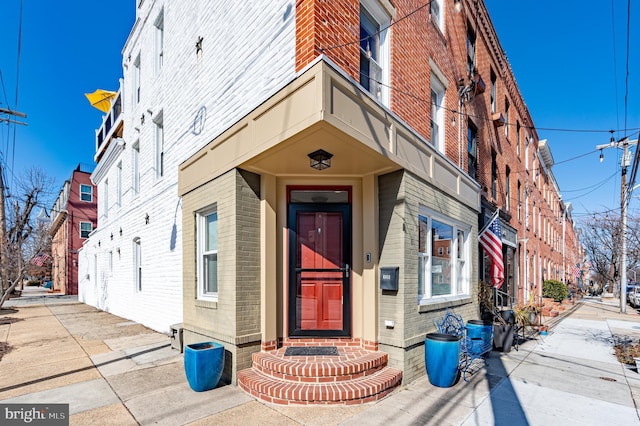 entrance to property with brick siding