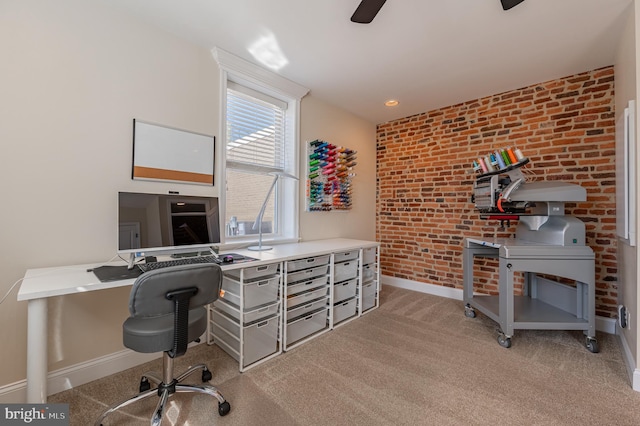 office space with baseboards, brick wall, and light colored carpet