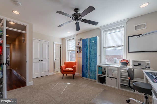 office featuring recessed lighting, visible vents, baseboards, and light colored carpet