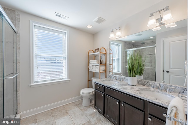 bathroom featuring a stall shower, a sink, and visible vents