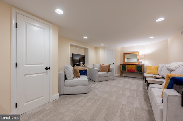 living room with recessed lighting, baseboards, and light colored carpet