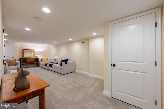 living area with recessed lighting, baseboards, and light colored carpet