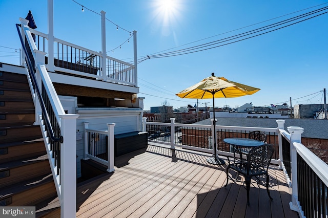 wooden terrace featuring a jacuzzi