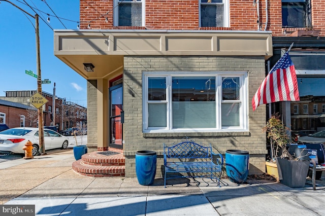 property entrance featuring brick siding