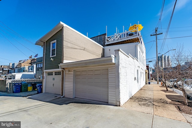 view of side of property with a garage and driveway