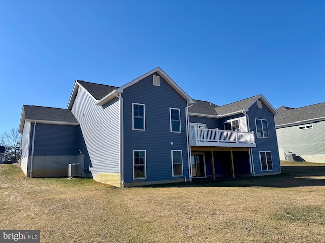 rear view of house with a lawn, a deck, and central air condition unit