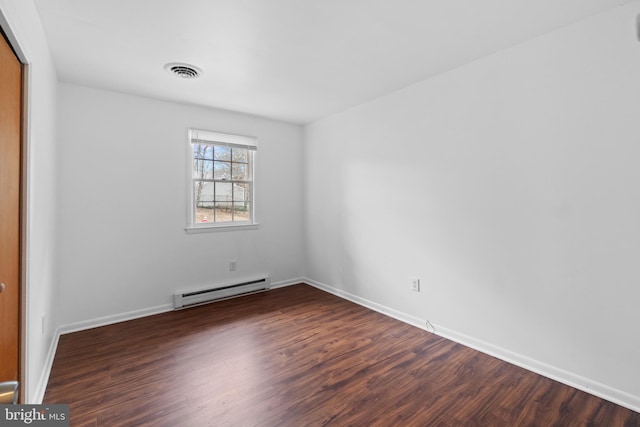 unfurnished room featuring dark wood-style flooring, visible vents, baseboards, and baseboard heating