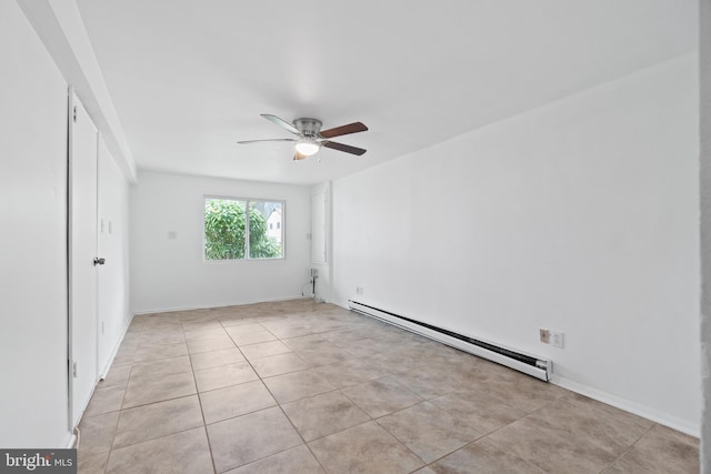 spare room with light tile patterned floors, a baseboard radiator, baseboards, and a ceiling fan