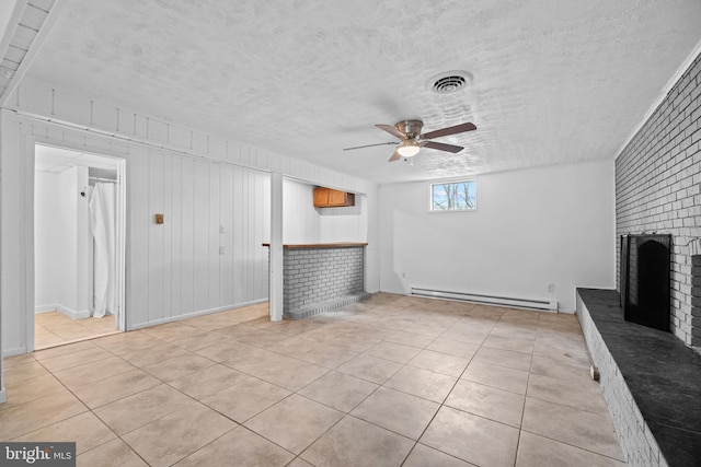 unfurnished living room featuring a fireplace, visible vents, baseboard heating, ceiling fan, and a textured ceiling