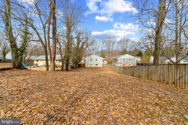 view of yard with a fenced backyard and a residential view