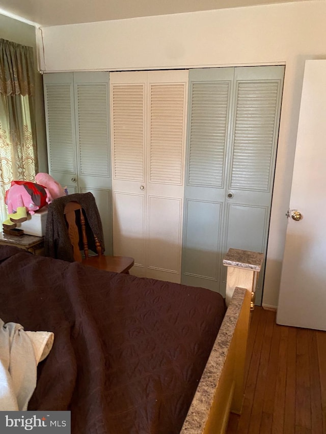 bedroom featuring a closet and wood finished floors