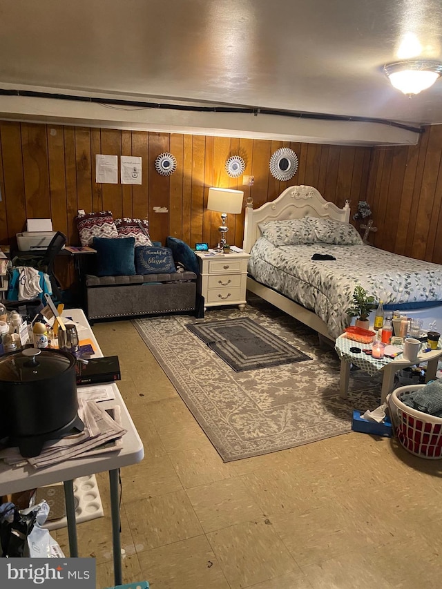 bedroom with wood walls and tile patterned floors