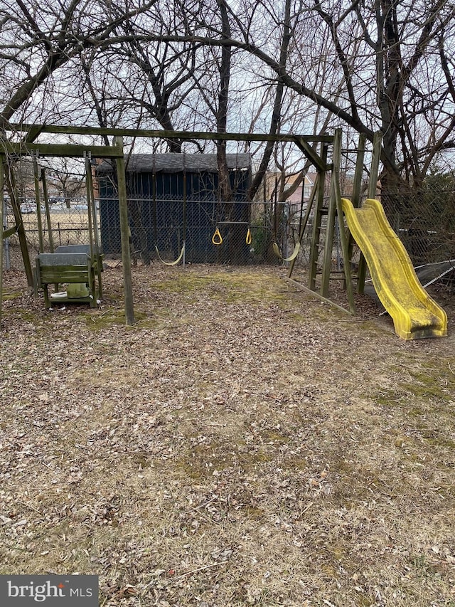 view of yard with playground community and fence