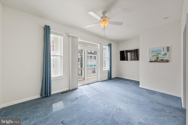 empty room with carpet floors, ceiling fan, and baseboards