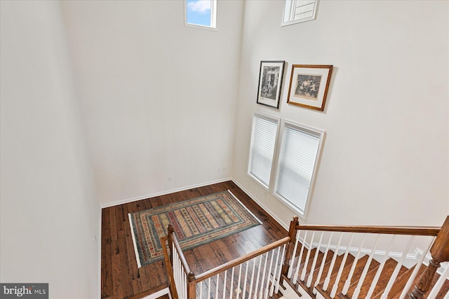 stairway featuring baseboards and wood finished floors