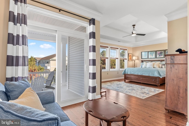 bedroom with baseboards, a ceiling fan, hardwood / wood-style flooring, ornamental molding, and access to exterior