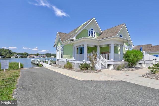 view of front of property featuring a porch and a water view