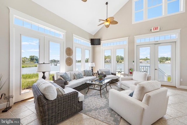 sunroom / solarium featuring lofted ceiling, french doors, and ceiling fan