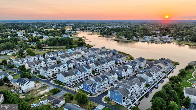 drone / aerial view featuring a residential view and a water view