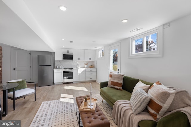 living room featuring recessed lighting and light wood finished floors