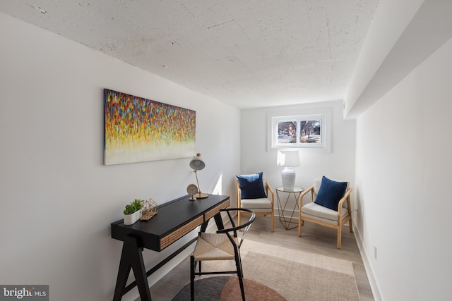 office space with light wood-style flooring and baseboards