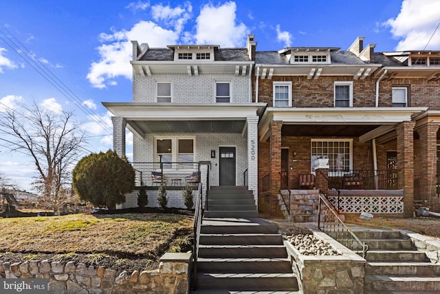 view of front of property with a porch and brick siding