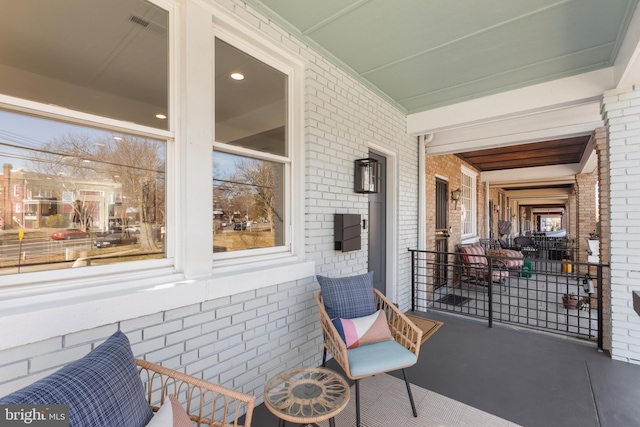 view of patio / terrace with a porch and visible vents