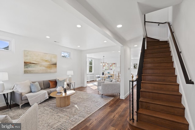 living area with dark wood-style floors, recessed lighting, stairway, and baseboards