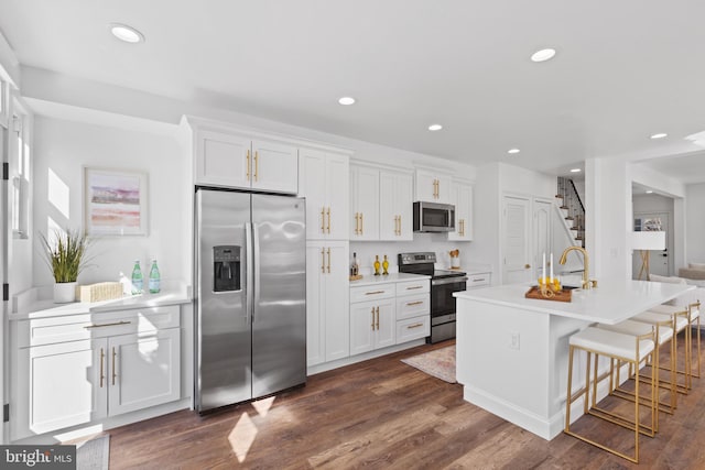 kitchen featuring stainless steel appliances, dark wood-style flooring, recessed lighting, and white cabinets