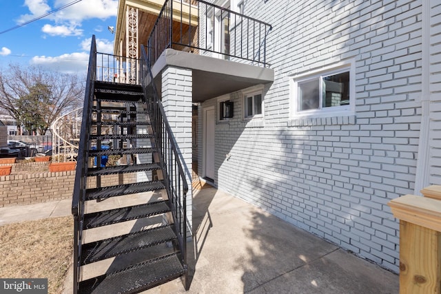 view of exterior entry featuring brick siding