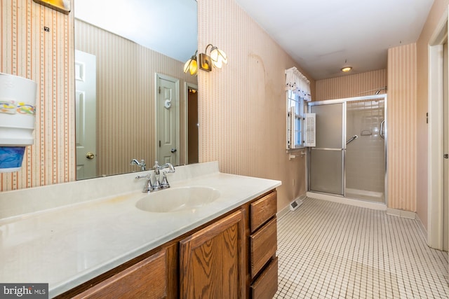 bathroom featuring a shower stall, tile patterned floors, vanity, and wallpapered walls