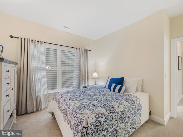 bedroom featuring light carpet, visible vents, and baseboards