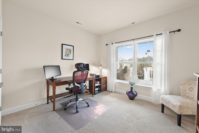 carpeted office space with visible vents and baseboards