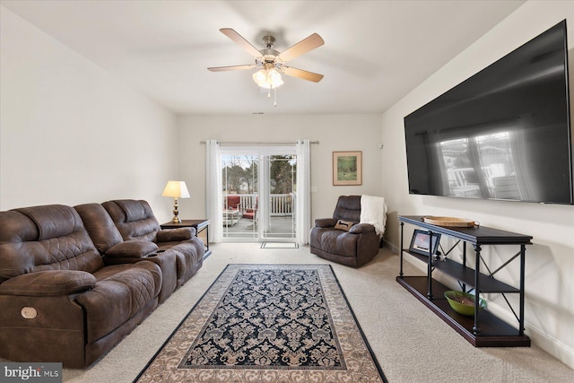 carpeted living room with ceiling fan and baseboards