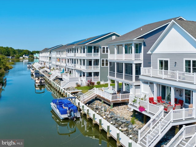 rear view of property with a water view