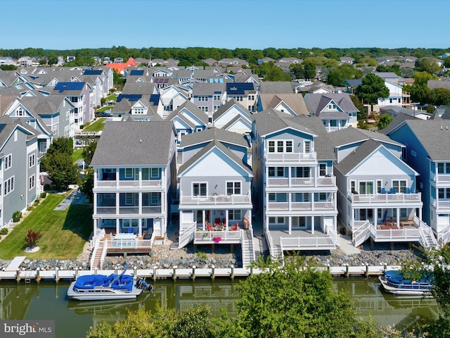 drone / aerial view featuring a water view and a residential view