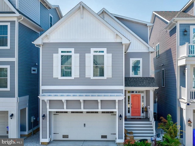 view of front of home featuring board and batten siding, driveway, a shingled roof, and an attached garage