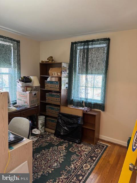 office with hardwood / wood-style flooring and baseboards