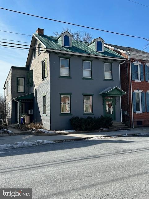 view of front of home with a chimney