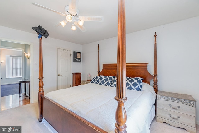 bedroom featuring a ceiling fan and light colored carpet